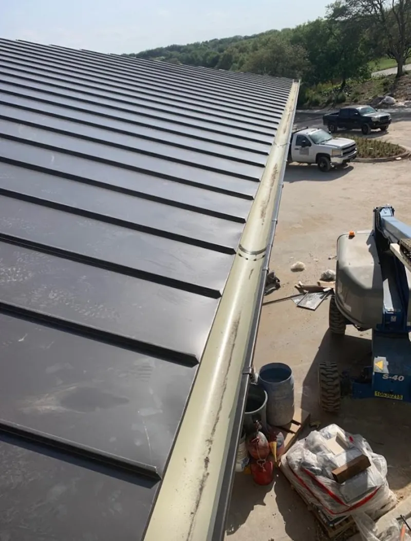 Standing seam panel and gutter detail on a metal roofing jobsite in Daytona Beach Shores